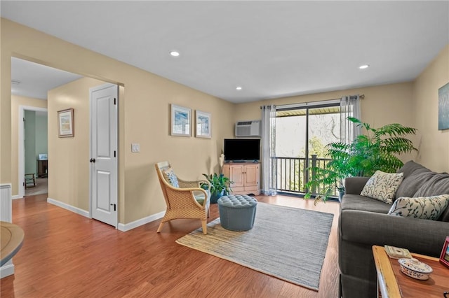 living room featuring baseboards, recessed lighting, and wood finished floors