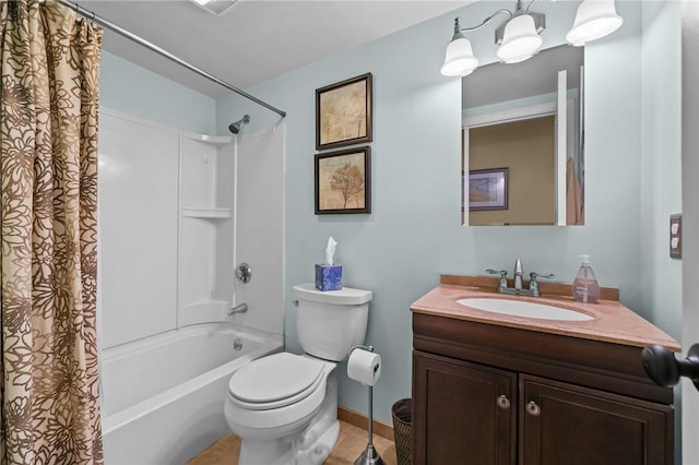bathroom with vanity, toilet, tile patterned floors, shower / bath combo with shower curtain, and baseboards