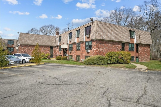 view of building exterior featuring uncovered parking