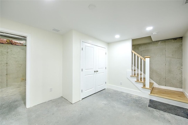 basement featuring recessed lighting, stairs, and visible vents
