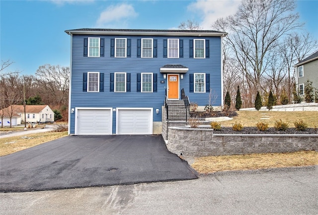 view of front of house with an attached garage, driveway, and entry steps