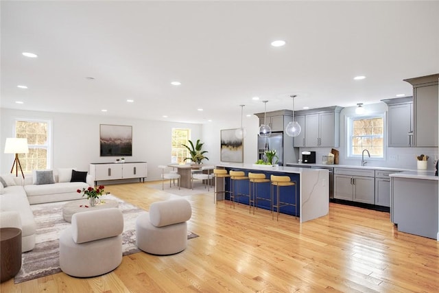 living area featuring light wood-style floors and recessed lighting