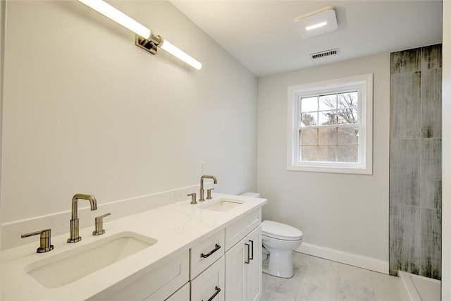 bathroom with a sink, baseboards, toilet, and visible vents