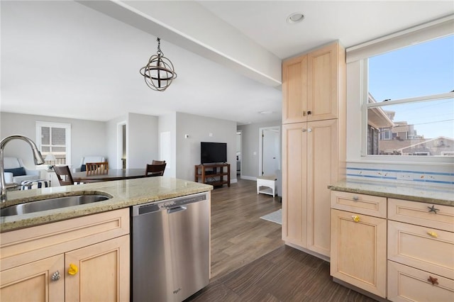 kitchen featuring a sink, light brown cabinets, open floor plan, dishwasher, and light stone counters