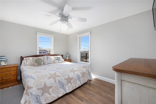 bedroom featuring baseboards, ceiling fan, and wood finished floors