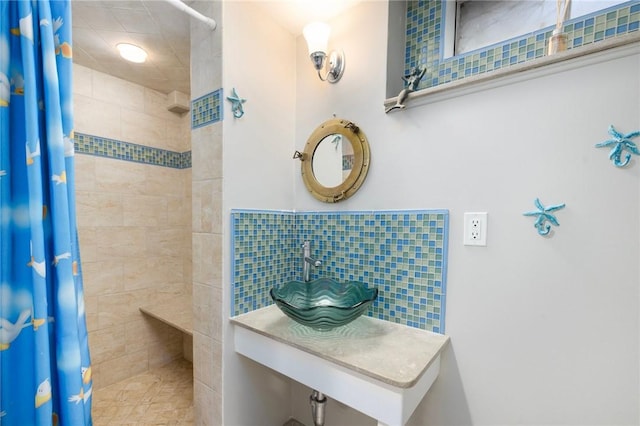 bathroom featuring a sink and a tile shower