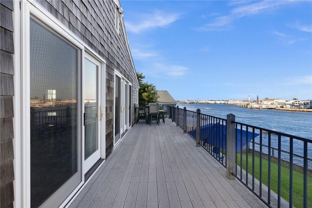 wooden deck featuring a water view