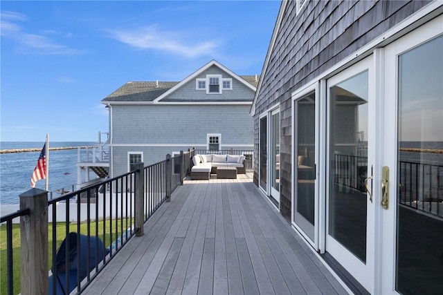 deck featuring an outdoor living space and a water view