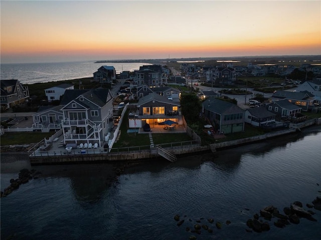 aerial view at dusk with a water view