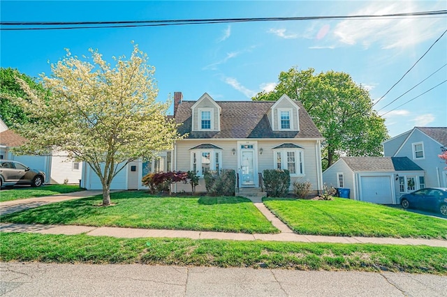cape cod house featuring an attached garage, driveway, a chimney, and a front lawn