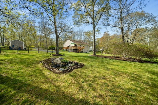 view of yard with stairway, fence, and a deck