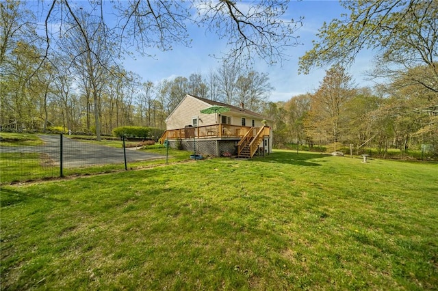 view of yard featuring stairway, a deck, and fence