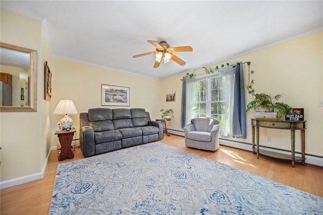 living room featuring crown molding, a baseboard radiator, ceiling fan, and wood finished floors