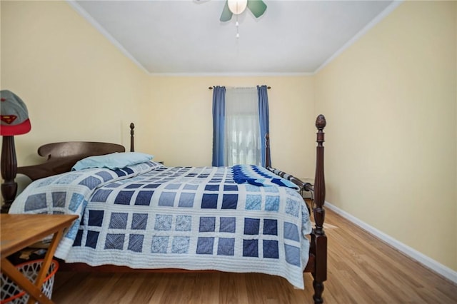 bedroom featuring baseboards, ornamental molding, a ceiling fan, and wood finished floors