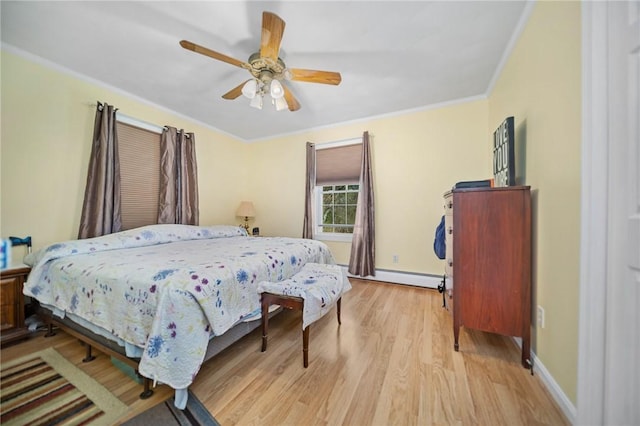 bedroom featuring ornamental molding, baseboards, ceiling fan, a baseboard heating unit, and light wood-style flooring