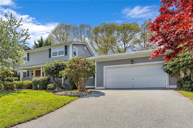 105 Quaker Dr, West Warwick, RI 02893 - traditional-style home with a garage, a front yard, and aphalt driveway
