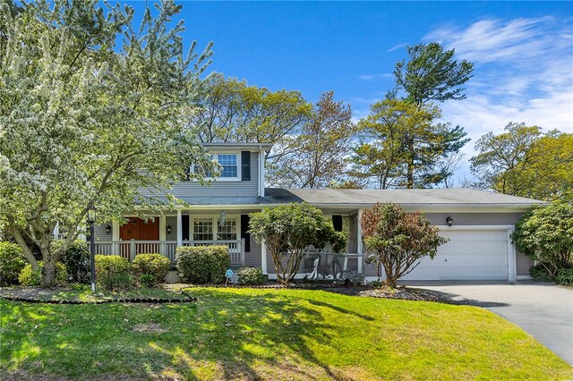 105 Quaker Dr, West Warwick, RI 02893 - traditional-style house featuring covered porch, aphalt driveway, a garage, and a front yard