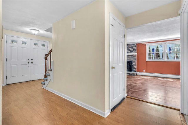105 Quaker Dr, West Warwick, RI 02893 - hall with baseboards, a baseboard radiator, wood-type flooring, and stairway