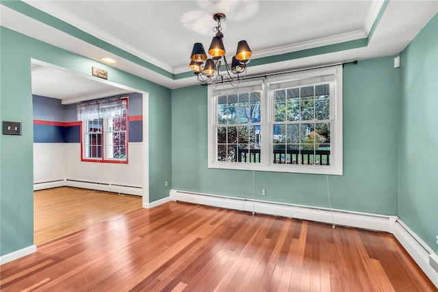 105 Quaker Dr, West Warwick, RI 02893 - unfurnished room with a chandelier, ornamental molding, baseboard heating, hardwood / wood-style flooring, and baseboards