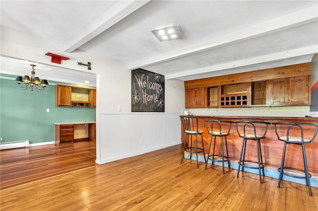 105 Quaker Dr, West Warwick, RI 02893 - bar with a baseboard radiator, an inviting chandelier, wainscoting, beamed ceiling, and light wood-style floors