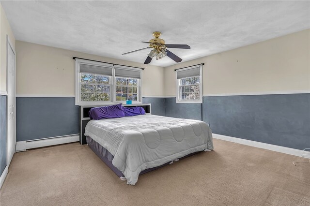 105 Quaker Dr, West Warwick, RI 02893 - carpeted bedroom with a baseboard heating unit, baseboards, and ceiling fan