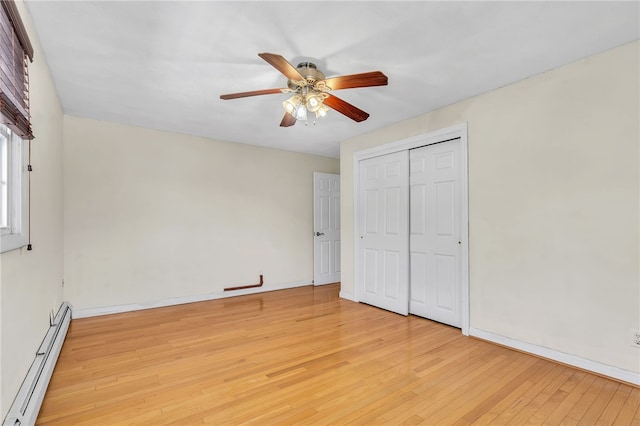 105 Quaker Dr, West Warwick, RI 02893 - unfurnished bedroom with a closet, a baseboard heating unit, baseboards, light wood finished floors, and ceiling fan