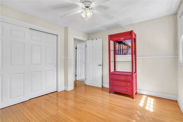 105 Quaker Dr, West Warwick, RI 02893 - unfurnished bedroom featuring baseboards, ceiling fan, a closet, and light wood-type flooring