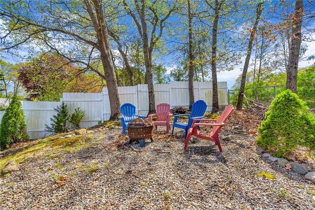 105 Quaker Dr, West Warwick, RI 02893 - view of yard with a fenced backyard and an outdoor fire pit