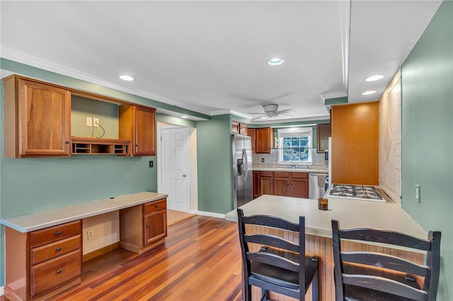 105 Quaker Dr, West Warwick, RI 02893 - kitchen featuring wood finished floors, a sink, open shelves, backsplash, and appliances with stainless steel finishes