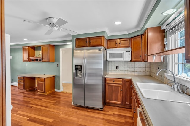 105 Quaker Dr, West Warwick, RI 02893 - kitchen with stainless steel fridge, a sink, open shelves, crown molding, and white microwave