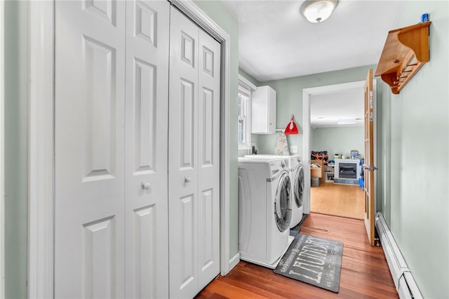 105 Quaker Dr, West Warwick, RI 02893 - washroom with wood finished floors, cabinet space, washing machine and clothes dryer, baseboards, and a baseboard radiator