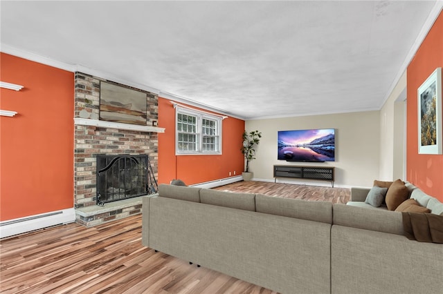 105 Quaker Dr, West Warwick, RI 02893 - living room featuring a baseboard heating unit, wood finished floors, a fireplace, crown molding, and baseboards