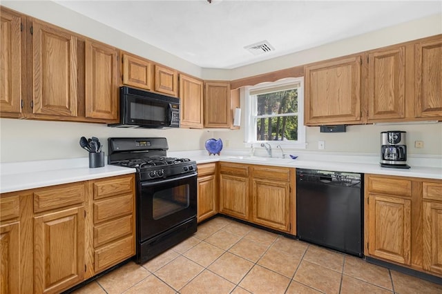 106 N River Dr, Narragansett, RI 02882 - kitchen with black appliances, a sink, light tile patterned flooring, light countertops, and brown cabinetry