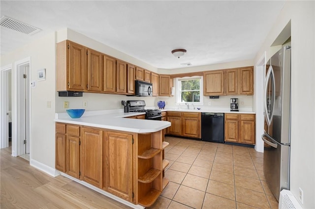 106 N River Dr, Narragansett, RI 02882 - kitchen with black appliances, a peninsula, open shelves, a sink, and light countertops