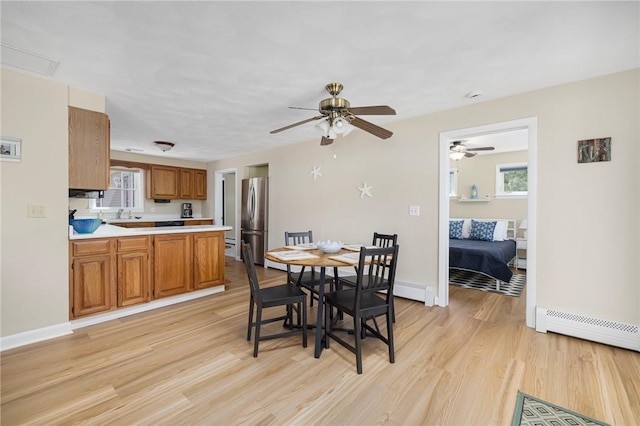 106 N River Dr, Narragansett, RI 02882 - dining room featuring light wood-style floors, baseboards, ceiling fan, and a baseboard radiator