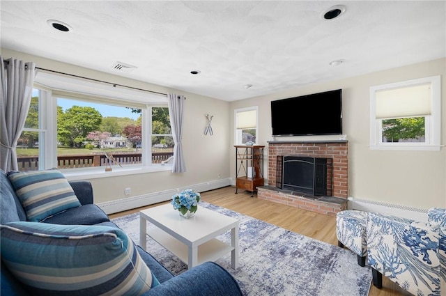 106 N River Dr, Narragansett, RI 02882 - living area featuring a baseboard radiator, wood finished floors, a fireplace, baseboards, and recessed lighting