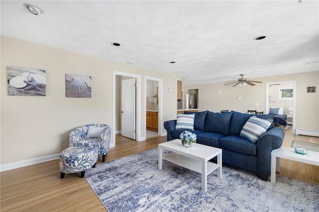 106 N River Dr, Narragansett, RI 02882 - living area featuring baseboards, wood finished floors, ceiling fan, and a baseboard heating unit