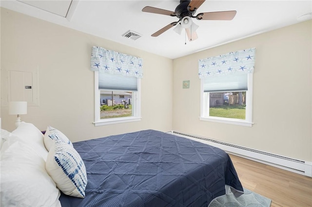 106 N River Dr, Narragansett, RI 02882 - bedroom with baseboard heating, wood finished floors, and ceiling fan
