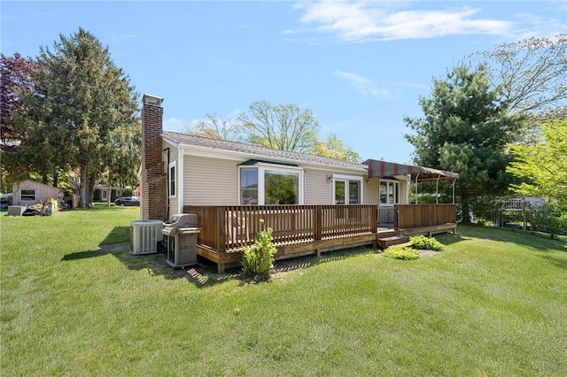 106 N River Dr, Narragansett, RI 02882 - rear view of property with a chimney, central AC unit, a deck, and a lawn