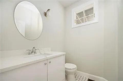 70 Shady Ln, Burrillville, RI 02859 - bathroom featuring vanity, toilet, and baseboards