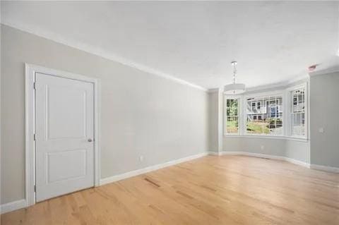 70 Shady Ln, Burrillville, RI 02859 - unfurnished room featuring wood finished floors, baseboards, and ornamental molding