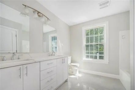70 Shady Ln, Burrillville, RI 02859 - full bathroom featuring plenty of natural light, double vanity, toilet, and baseboards