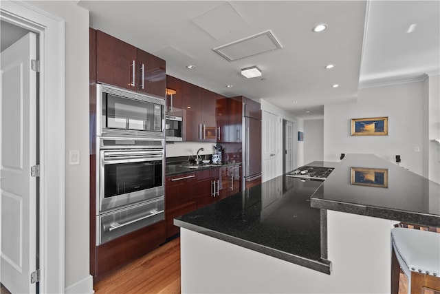 1 Tower Dr Unit 1502, Portsmouth, RI 02871 - kitchen with a kitchen island, a warming drawer, dark countertops, a sink, and built in appliances