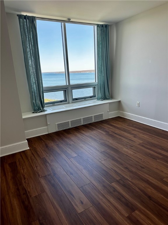 1 Tower Dr Unit 1502, Portsmouth, RI 02871 - empty room with dark wood-type flooring, baseboards, a water view, and visible vents