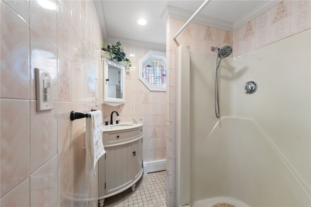 full bath with tile patterned flooring, ornamental molding, vanity, a shower, and tile walls