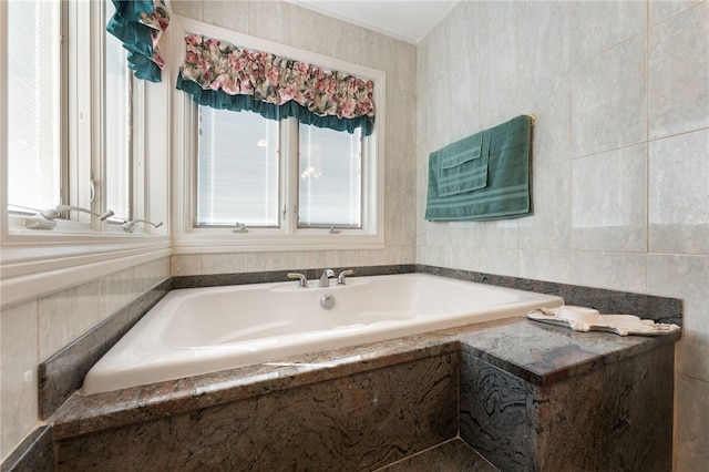 bathroom with a bath and tile walls