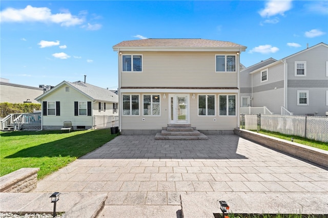 back of house featuring a lawn, fence, and a patio