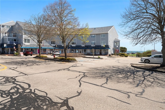 view of street with a residential view, sidewalks, and curbs