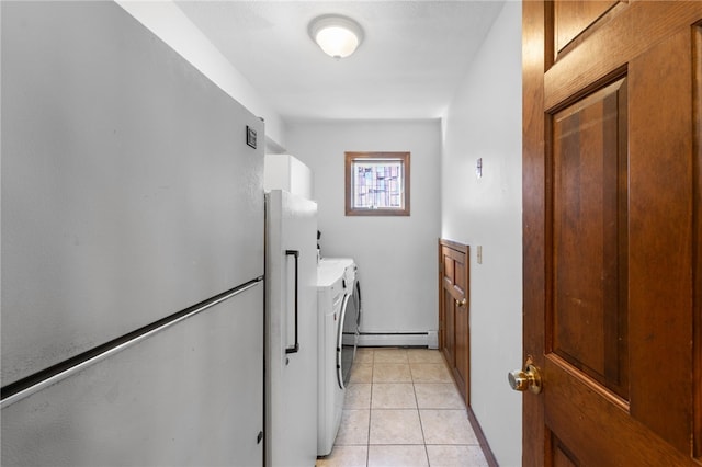 washroom with laundry area, independent washer and dryer, a baseboard heating unit, and light tile patterned floors