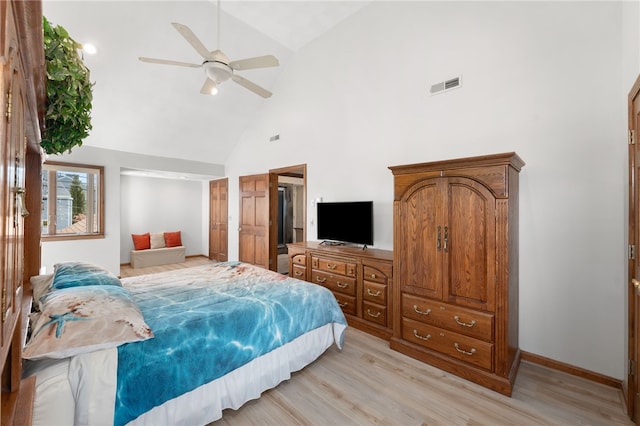 bedroom featuring ceiling fan, light wood-style floors, high vaulted ceiling, baseboards, and visible vents